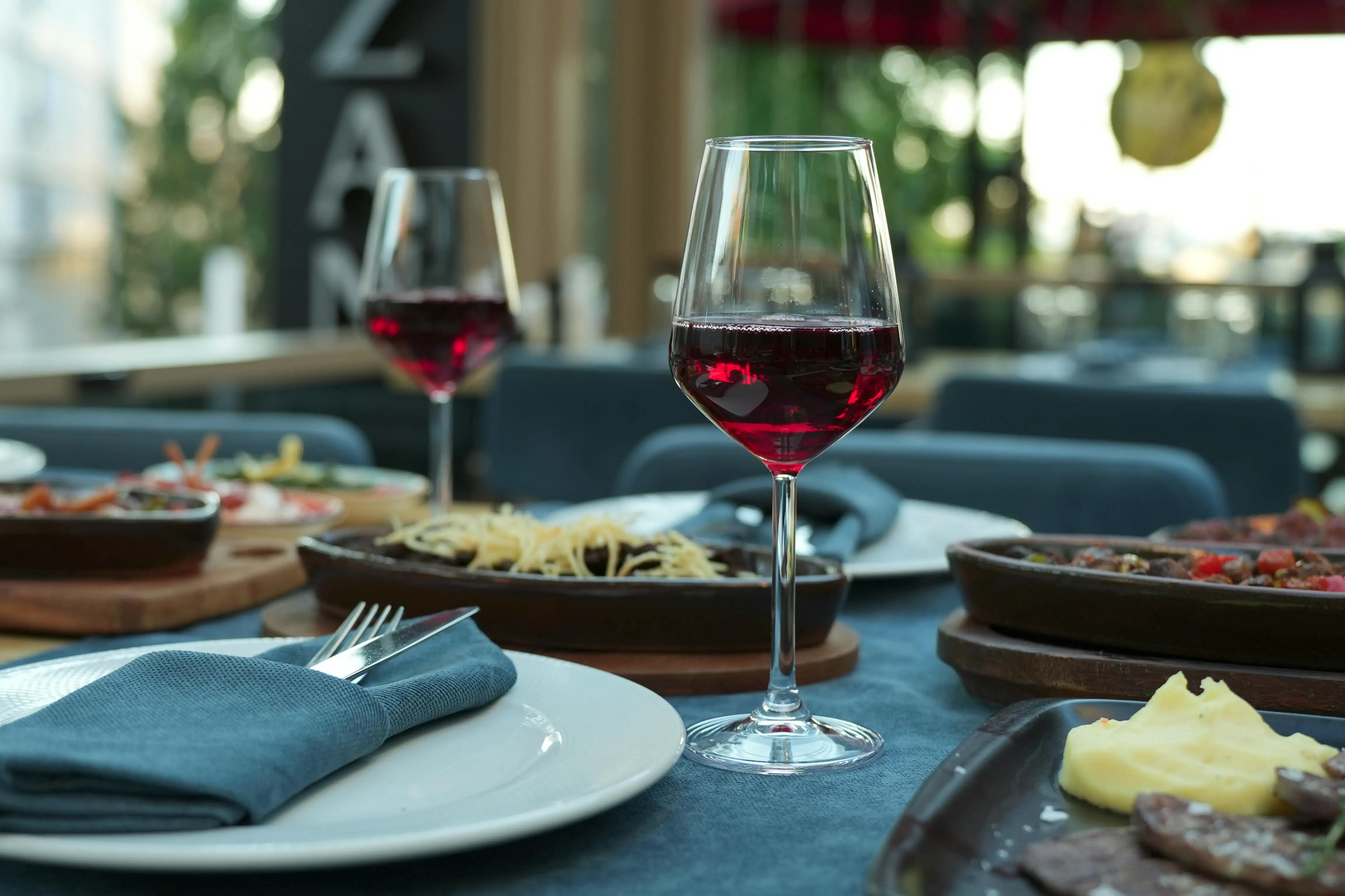 Sommelier pouring a curated wine pairing at Juniper Table